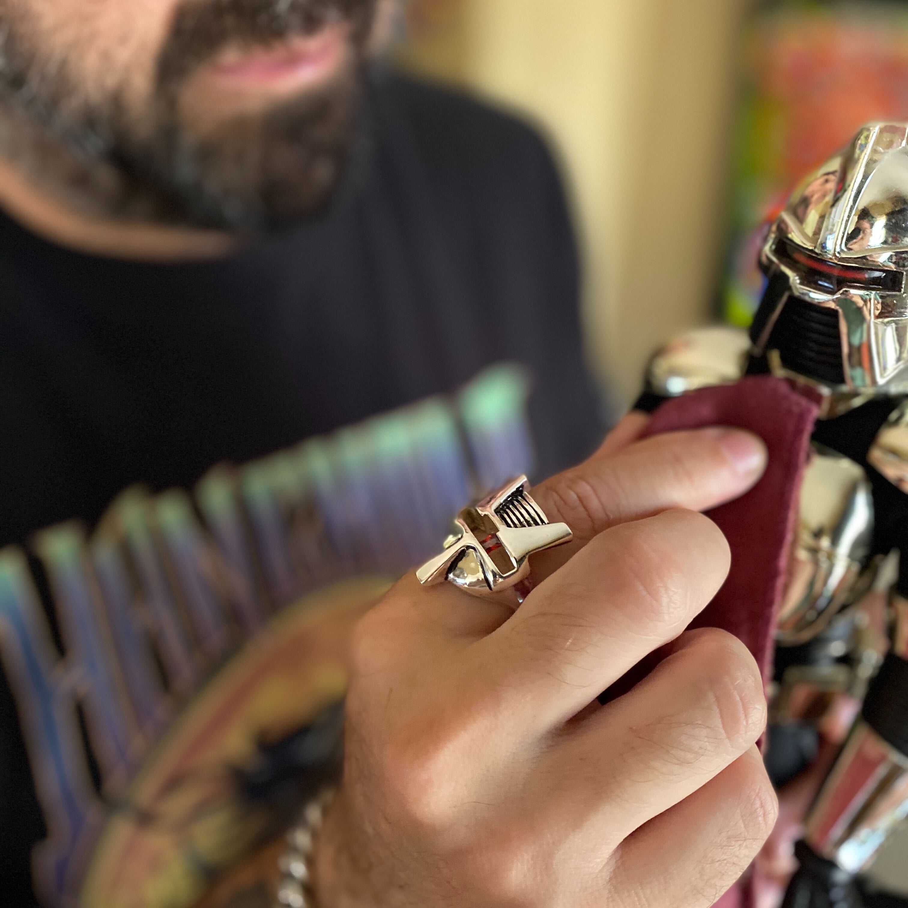 shot of a man wearing the raider ring playing the a battlestar galactica toy
