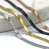 shot of the of the gunmetal, silver, gold and rose gold herring bone chains side by side on marble