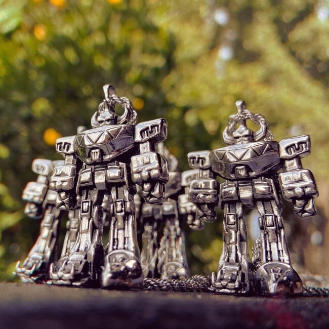 Image of multiple megazord pendants standing together from the mighty morphin power rangers