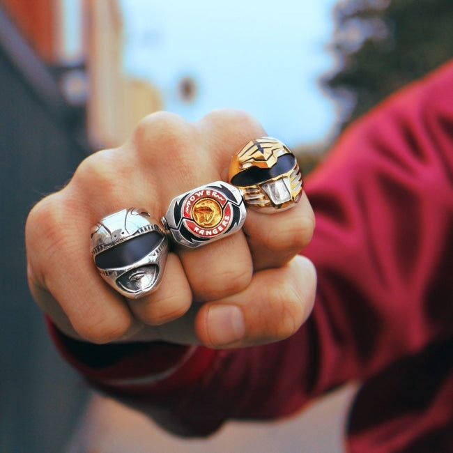 shot of a man in red with his fist out wearing the red ranger, white ranger and morpher ring