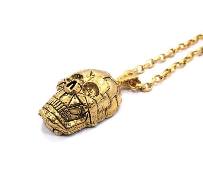 angle of the Rivet Skull Pendant in gold from han cholo skulls collection