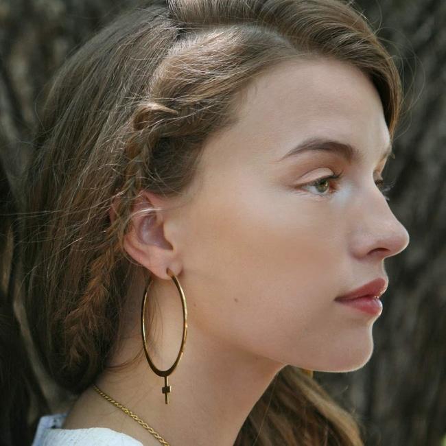 shot of the sex symbol earrings on a woman from the han cholo shadow series collection