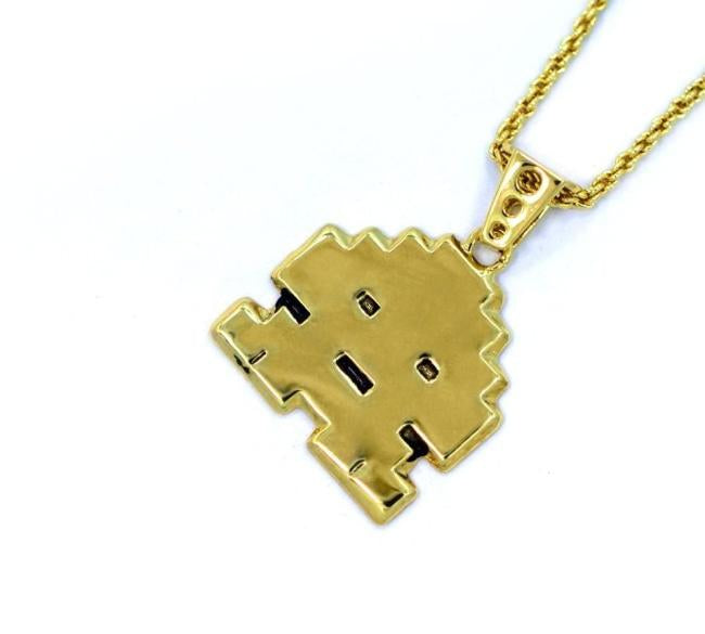 right angled view of the Stoney invader pendant in gold on a white background