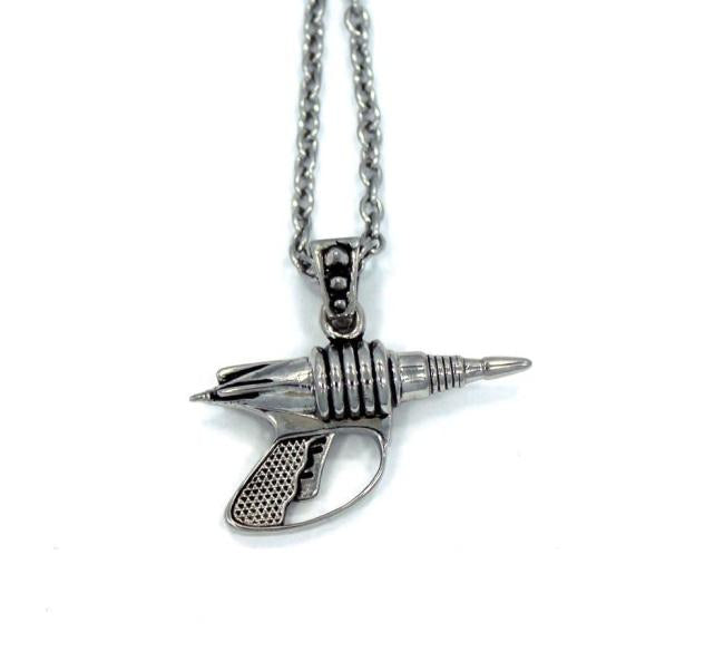back view of the Zap pendant in silver on a white surface