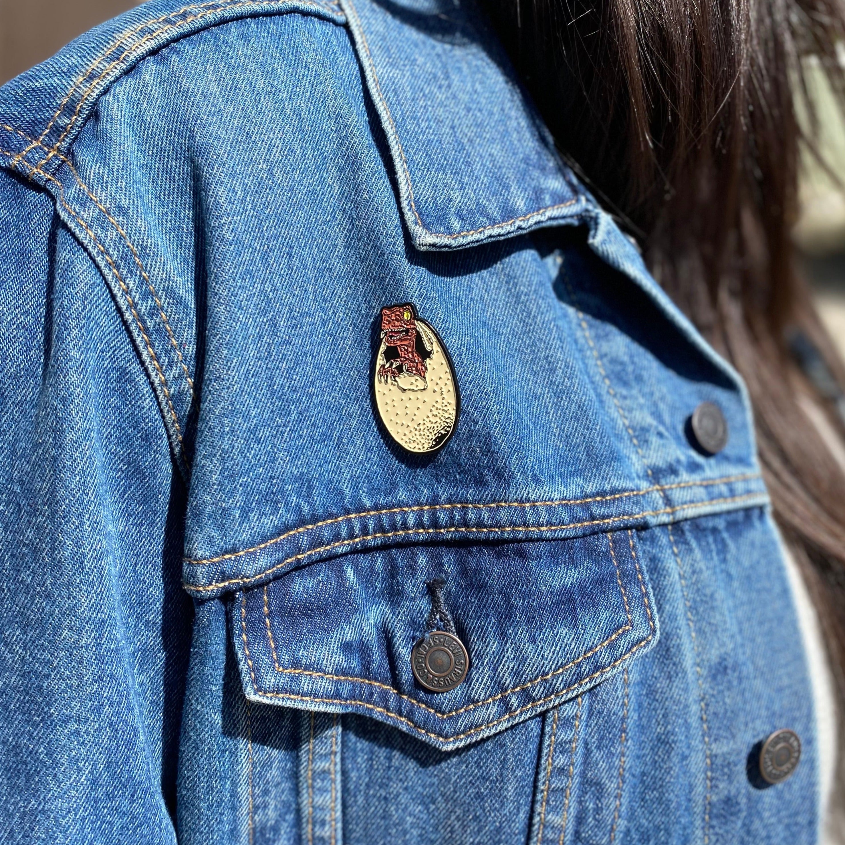 jurassic park dinosaur enamel pin on jean jacket, jurassic park pin