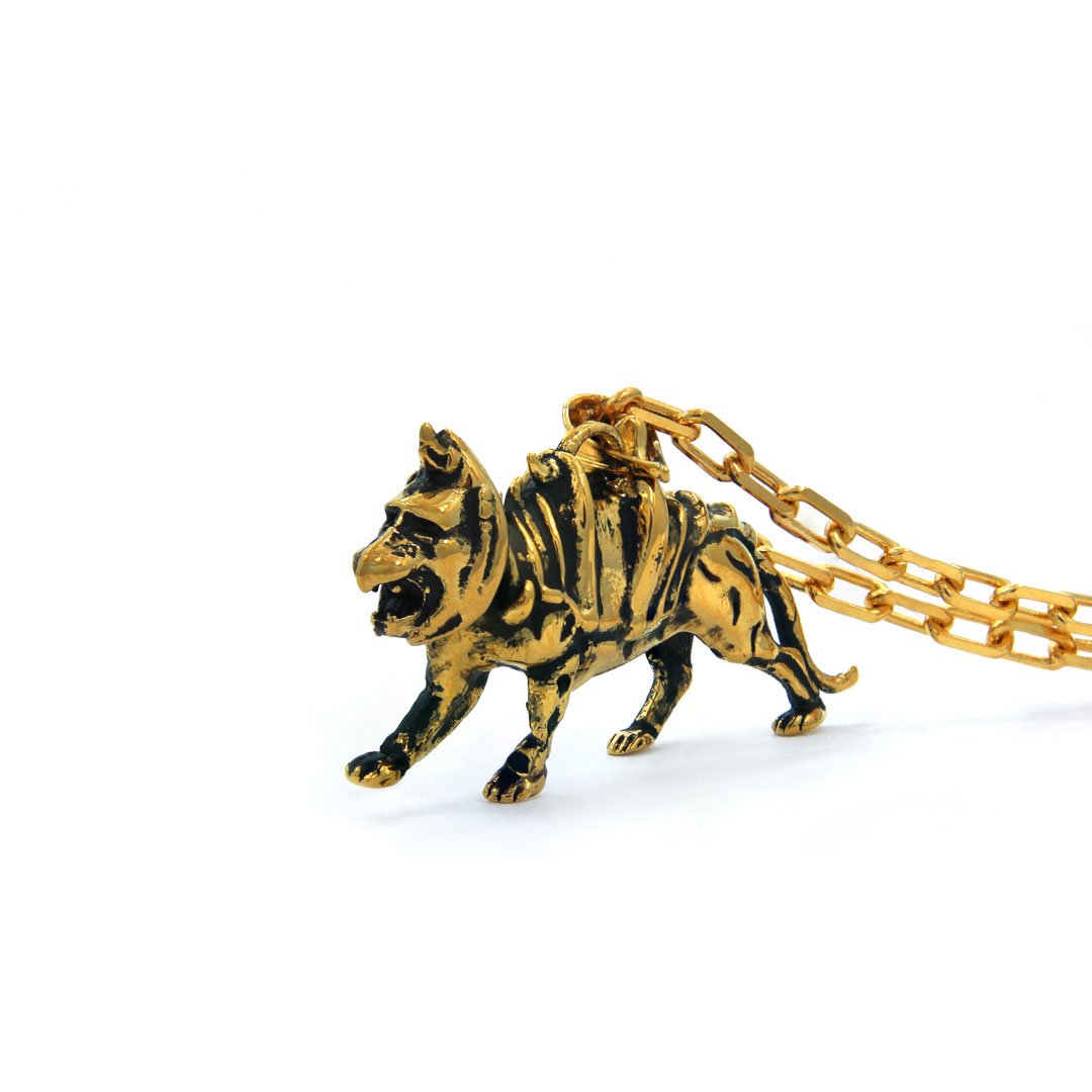 left side of the battlecat pendant in gold from the masters of the universe collection