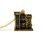 back of the castle grayskull pendant in gold from the masters of the universe collection