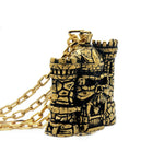 left side of the castle grayskull pendant in gold from the masters of the universe collection