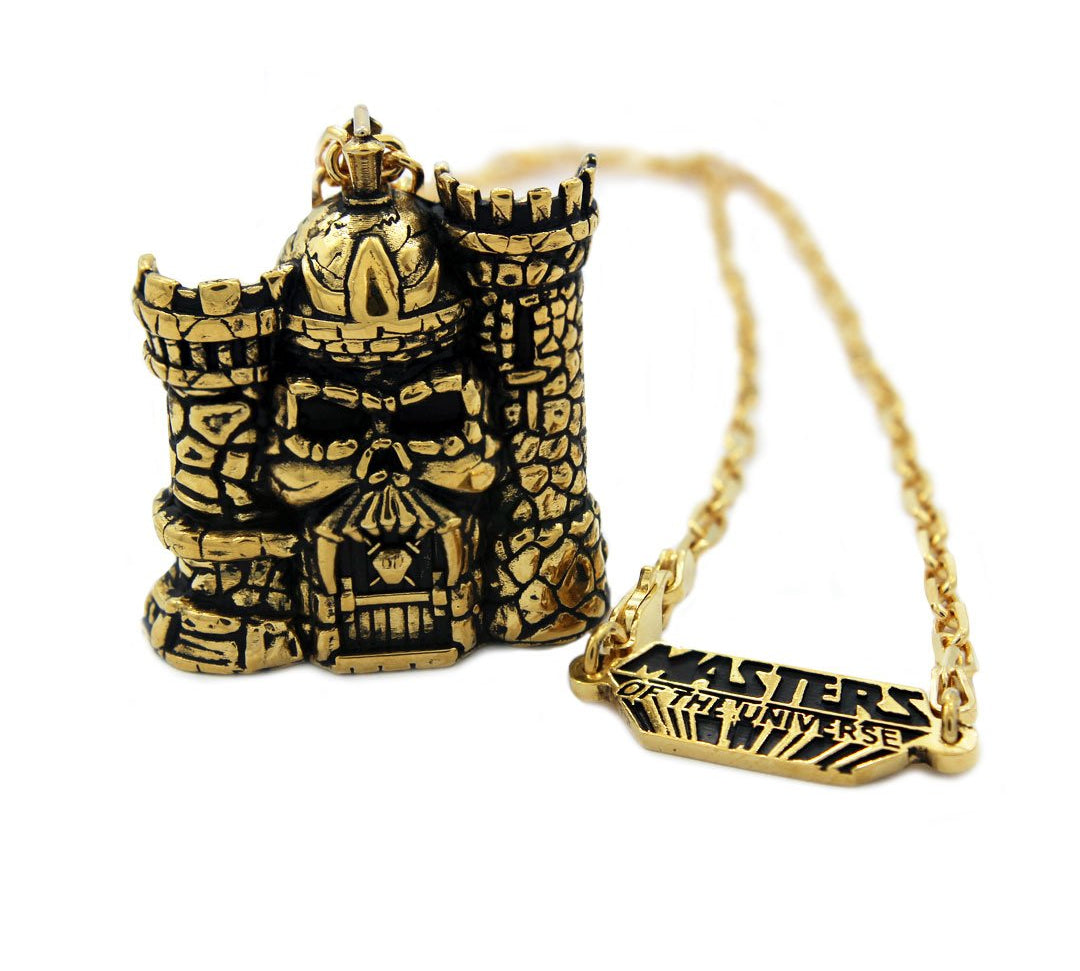 front of the castle grayskull pendant in gold from the masters of the universe collection