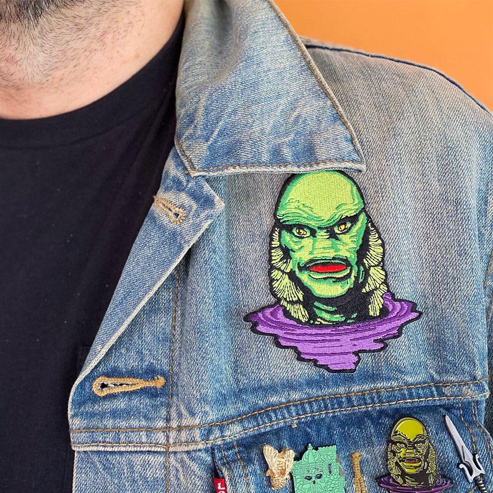 photo of a man wearing a blue denim jacket with the creature lurking patch on the jacket
