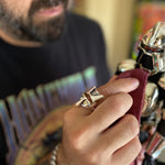 shot of a man wearing the raider ring playing the a battlestar galactica toy