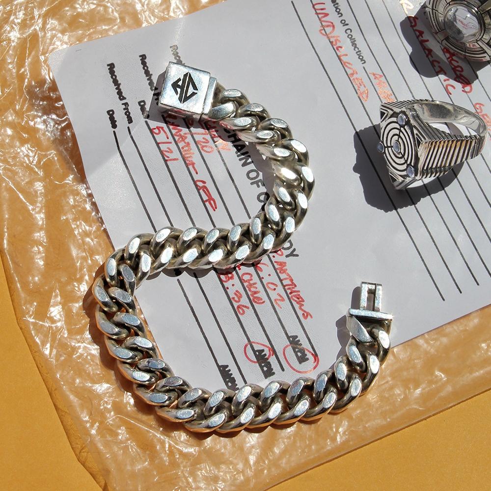 shot of the classified chain bracelet on a top secret document