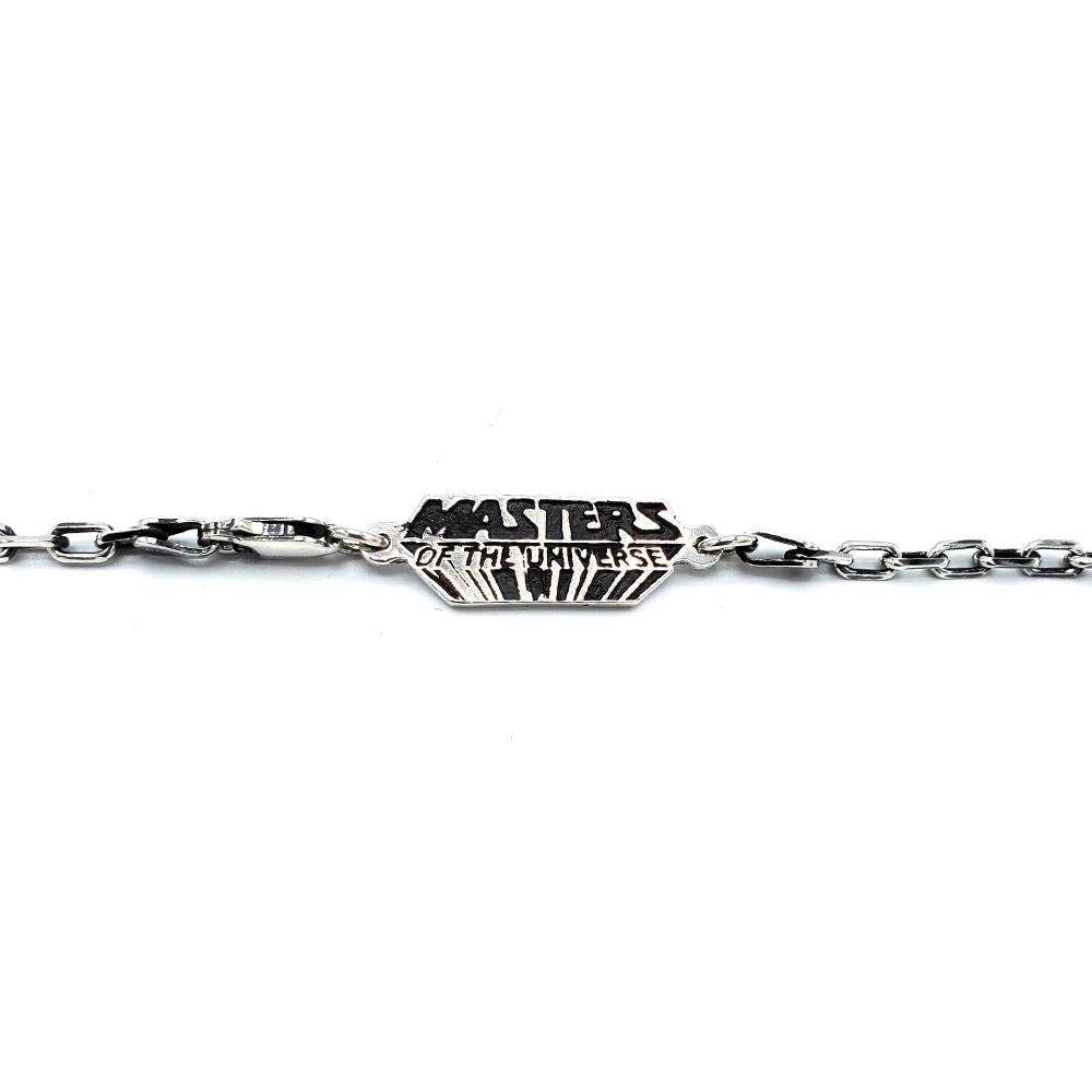 shot of the masters of the universe jewelry tag on the sterling silver cable chain