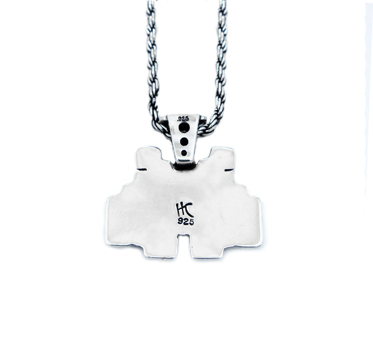 back view of the smiley invader pendant in silver on a white background