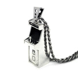 right angle view of the Arcade Machine Pendant in silver on a white background