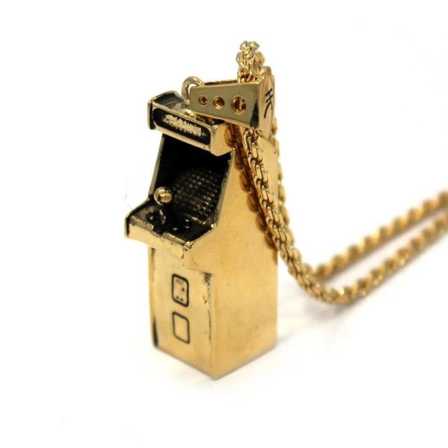 right angle view of the Arcade Machine Pendant in gold on a white background