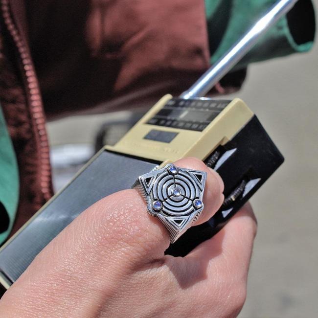 shot of a man holding a vintage radio wearing the awoken ring