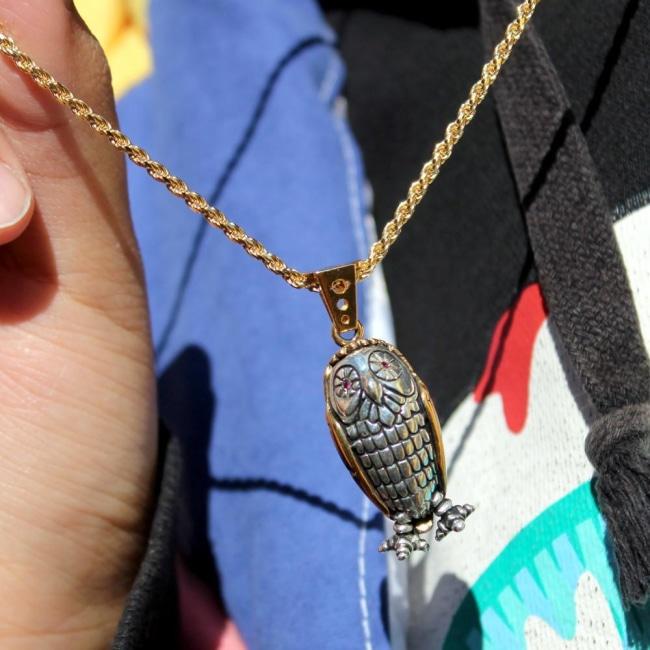 shot of a girl wearing the Baby Bobo Owl Pendant from the han cholo fantasy collection