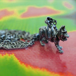 left side of the battlecat pendant in silver on a colorful masters of the universe surface