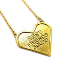 angled view of the best friends squad gold heart shaped pendant pointing to the right