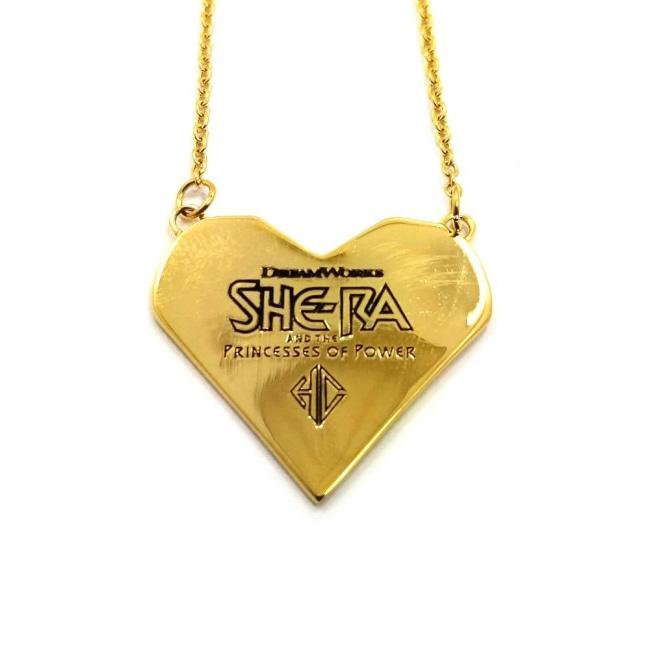 back view of the best friends squad pendant showing the she-ra logo and legal line below logo