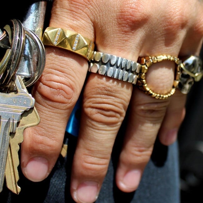 shot of a man wearing the Big Spike Stone Ring in gold from the han cholo precious metal collection