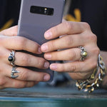 shot of a man wearing 2 of the the Black Hole Sun Ring in Silver from the han cholo collection
