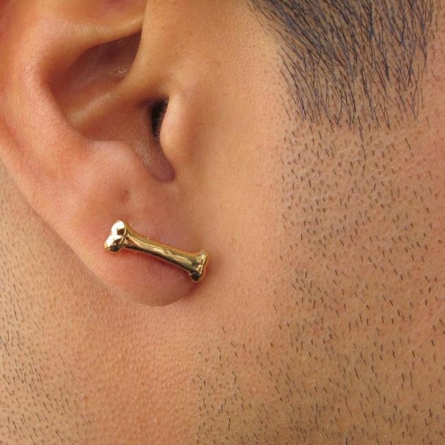 shot the Bone Earrings in gold on a man from the han cholo shadow series collection