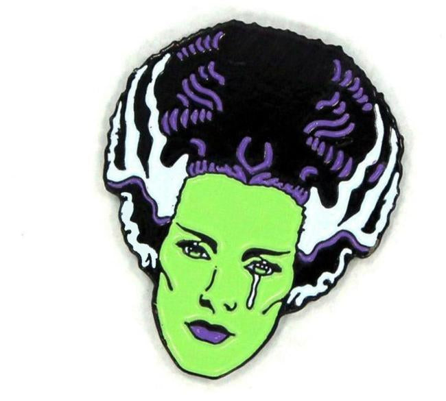 close up alngle of the bride tears enamel pin from the universal monsters jewelry collection