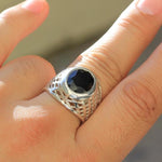 shot of the Caged Class Ring on a mans hand