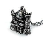 3/4 view of the castle grayskull pendant in silver from the masters of the universe collection
