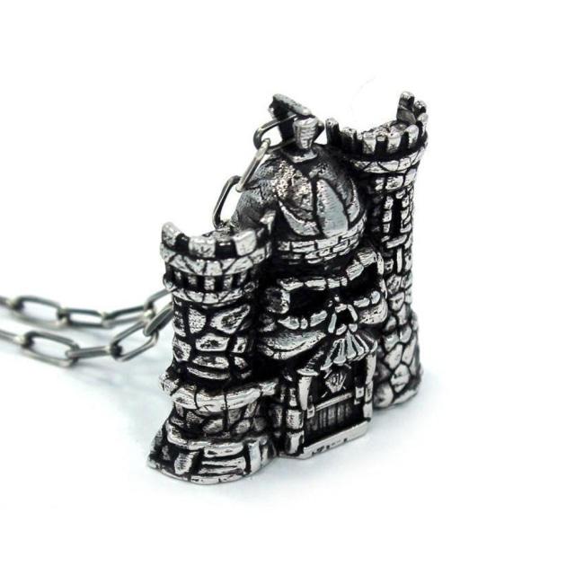 left side of the castle grayskull pendant in silver from the masters of the universe collection