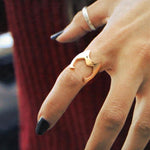 catra helmet ring fitted on the index finger of a girl with her fingers spread open