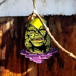 shot of the creature lurking enamel pin on a wooden background