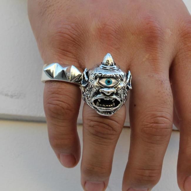 shot of a man wearing the cyclops ring and the big spike ring on his hand