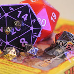 shot of the d20 stud earrings, d20 ring and d20 cufflinks on a classic fantasy vhs cover
