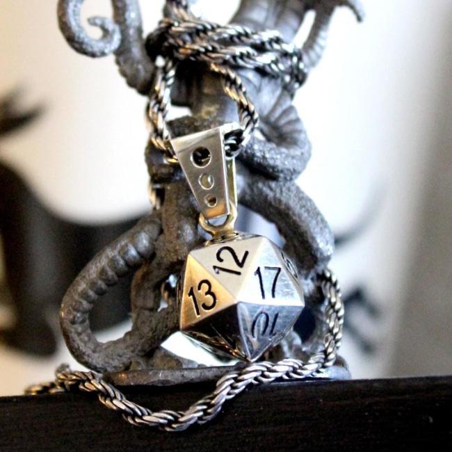 shot of the dice 20 pendant wrapped araound a demogorgon figure from D&D