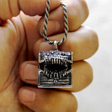 Dungeons & Dragons Mimic Monster Necklace, Hand holding necklace for close up view of mimic pendant in silver