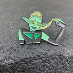shot of the double trouble enamel pin leaning on a shiny black surface
