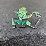 shot of the double trouble enamel pin leaning on a shiny black surface