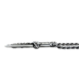 shot of the Dragon Dagger Pendant laying flat on a white surface showing side detail