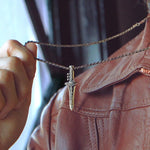 photo of a man in a brown leather jacket showing the green ranger dragon dagger pendant on a chain