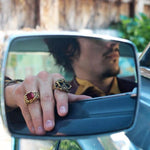 shot of a man in a classic car wearing the emperor nugget ring in gold