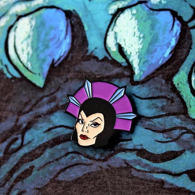 The Evil-Lyn Enamel Pin on a castle grayskull graphic  from the masters of the universe