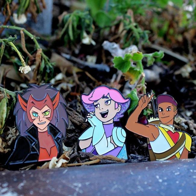 shot outside of the Catra, Princess Glimmer and Archer bow pins with a natural background