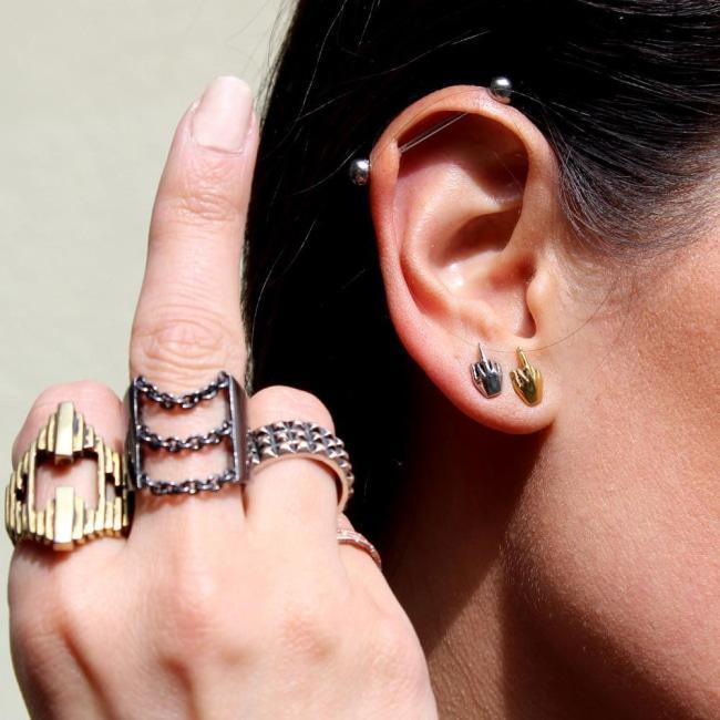 shot of a woman wearing han cholo rings and the Fu Earrings in silver