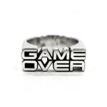 the front view of the game over ring by han cholo on a white background casting a shadow