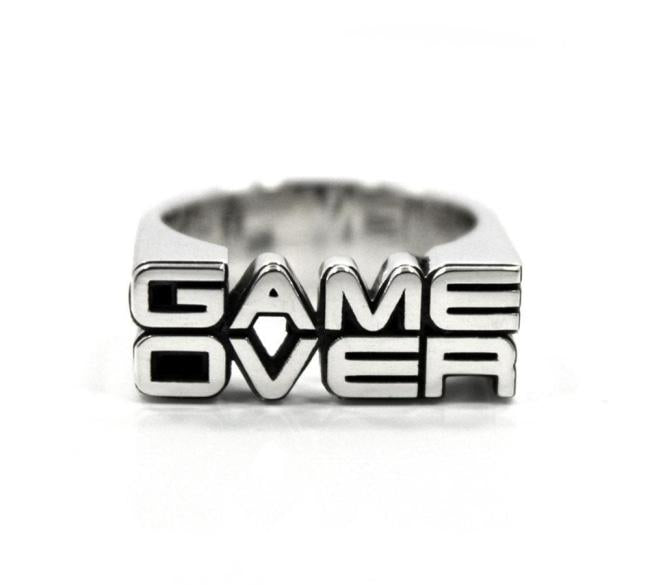 the front view of the game over ring by han cholo on a white background casting a shadow
