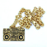front of the Ghetto Blaster Necklace in gold from the han cholo music collection
