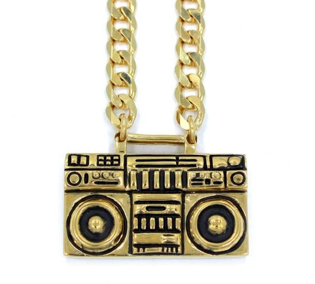 front of the Ghetto Blaster Necklace in gold from the han cholo music collection
